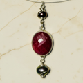 Close-up detail of ruby and pearl pendant